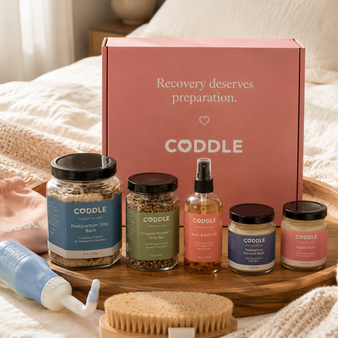 CODDLE postpartum recovery kit with herbal sitz bath, mother’s milk tea, massage oil, perineal balm and nipple balm.