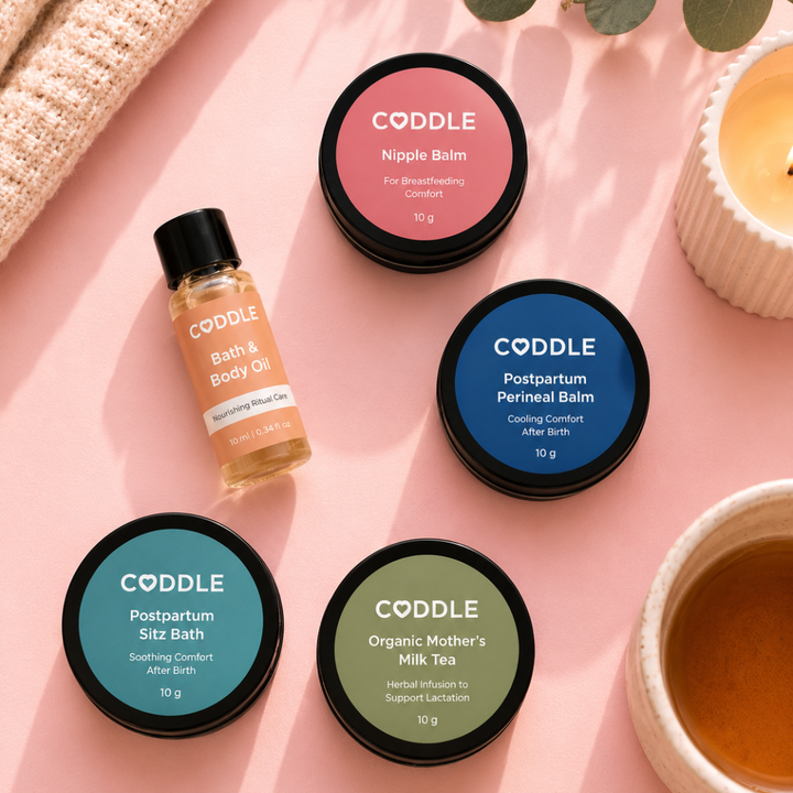 CODDLE Mini Postpartum Recovery Kit packed in a blush cosmetic pouch with postpartum recovery essentials, perfect for a hospital bag, travel, or bedside recovery care.