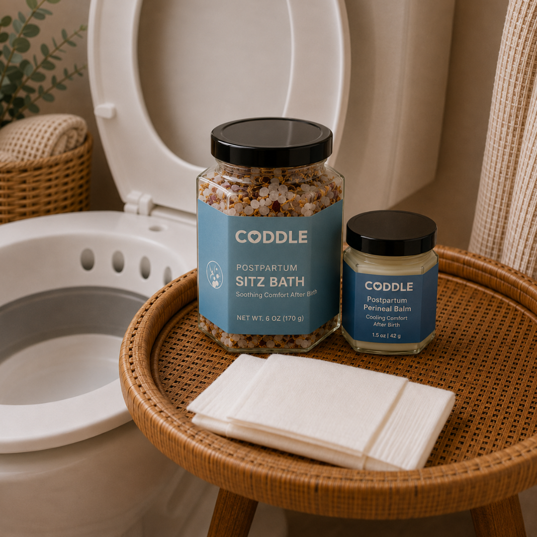 CODDLE Perineal Care After Birth Kit featuring Postpartum Sitz Bath, Postpartum Perineal Balm, postpartum wipes, and a sitz bath basin arranged in a bright bathroom for soothing postpartum recovery after birth.