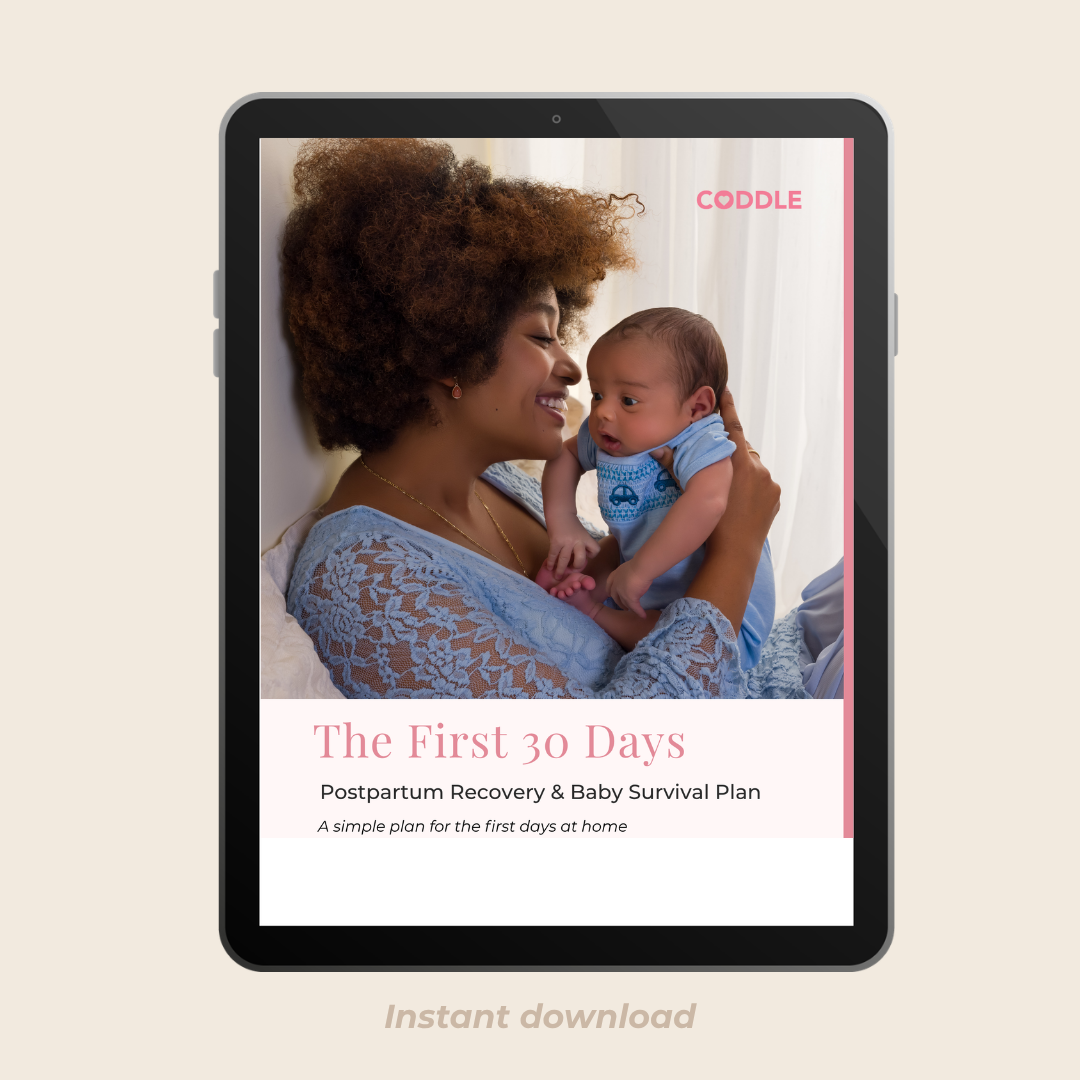 Mom holding a baby during postpartum recovery