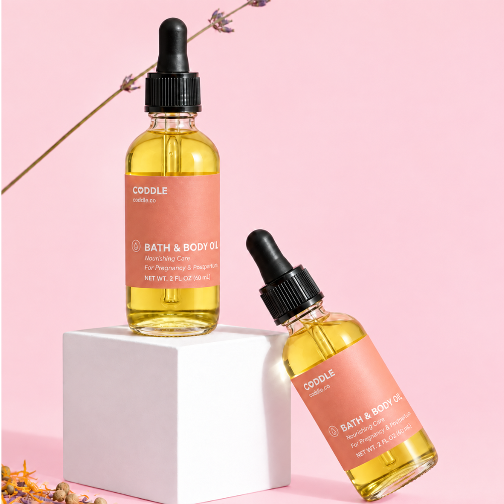 CODDLE Bath & Body Oil with lavender in a premium studio product photo featuring a blush background and white pedestal.