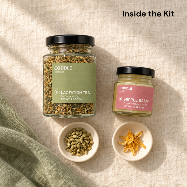 Overhead view of CODDLE Lactation Tea and Nipple Balm on cream linen, with small dishes of fennel seeds and calendula petals beside them.