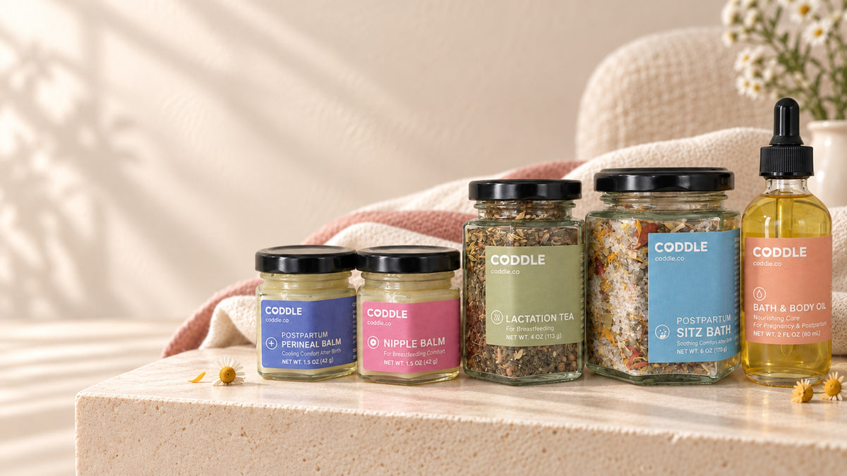 CODDLE postpartum recovery essentials including perineal balm, nipple balm, body oil, lactation tea and postpartum sitz bath.