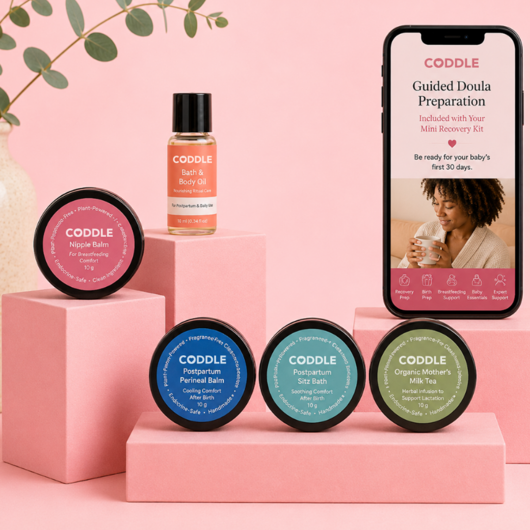 CODDLE Mini Postpartum Recovery Kit featuring Bath & Body Oil, Nipple Balm, Postpartum Perineal Balm, Postpartum Sitz Bath, Organic Mother's Milk Tea, and Guided Doula Preparation on a premium blush display