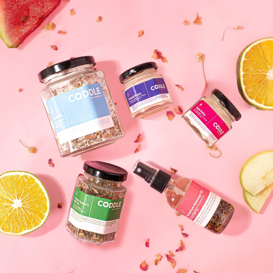 Plant-powered postpartum care kit with herbal sitz bath, perineal balm, nipple balm, massage oil, and lactation tea for gentle postpartum care.