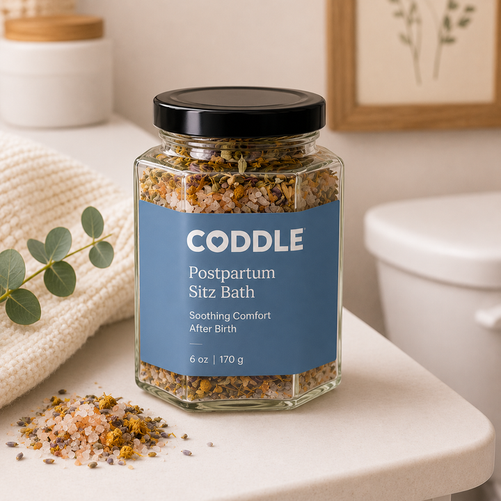 CODDLE Postpartum Sitz Bath recovery soak featuring mineral-rich bath salts and soothing herbs in a hexagon glass jar for gentle postpartum comfort and healing after birth.
