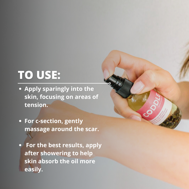 Applying CODDLE postpartum massage oil to skin for gentle after-birth body care and relaxation.